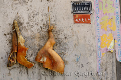 Dry cured Ham legs hanging on an outside wall in Hongcun China