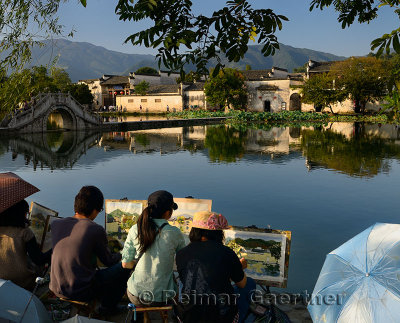 Group of student painters at South Lake in Hongcun World Heritage Site Anhui Province China