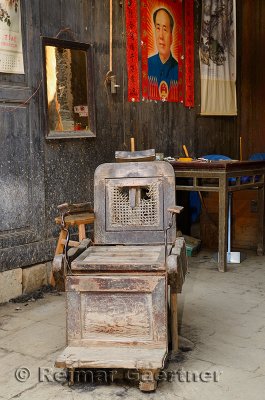 Old barber shop chair with Mao Zedong poster in ancient Chengkan village China