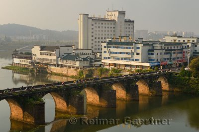 Morning rush on Ming Dynasty Zheng Hai bridge over Xinan river in Huangshan City formerly Tunxi China