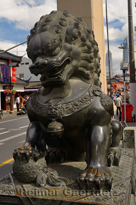 Bronze male guardian lion at the gate to Fangbang road Old Street in Shanghai China