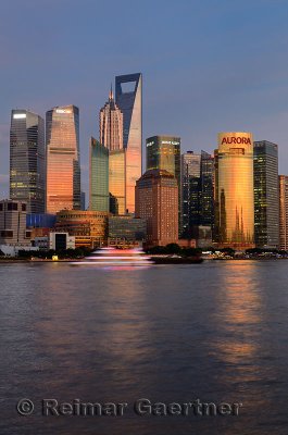 Dusk red glow on high rise towers reflected in Huangpu river of Shanghai China