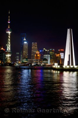 Night lights of Pudong high rise towers and Peoples Heroes Monument Huangpu river Shanghai China