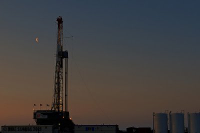 Spring  Moonset Over Ensign Rig 92 Belle Plaine SK.