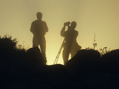 Sunrise in front of two photographers;  Morro Bay area, CA.