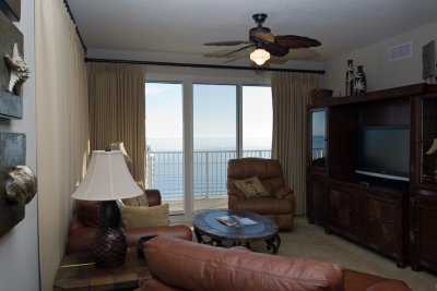 Living room offers great ocean view & access to wrap-around balcony.