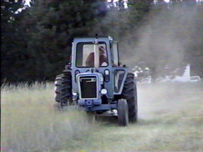 Opie mowing field. Had to open door for ventilation.jpg