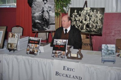 Eric Buckland Displaying His Books
