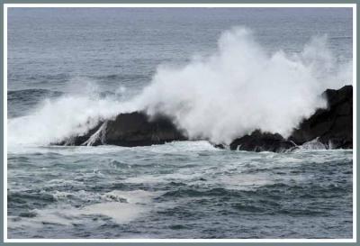 Big wave meets big rock.