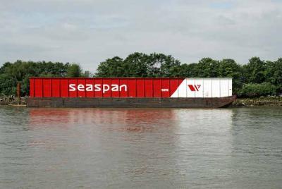 Empty wood chip barge moored in the river.