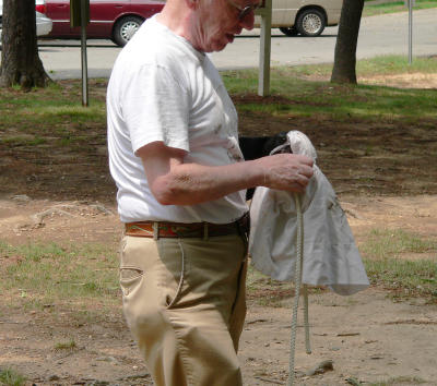 Kent opens bag containing smaller chick which Jeff had lowered to the ground with a rope.