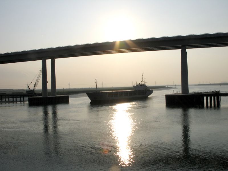 The ship passes under the new bridge.