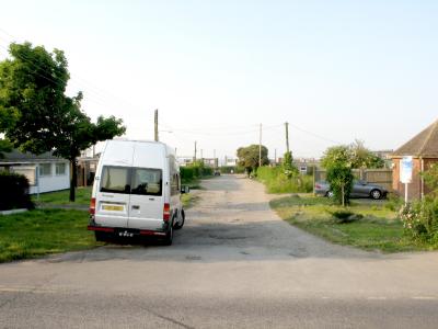 Nutts Avenue. Another dirt road. Police station is on the right.