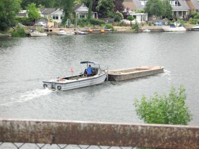Dumb barge being pushed downriver