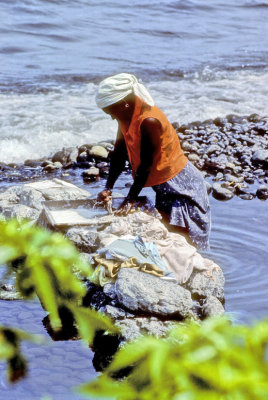 Woman washing by the sea...