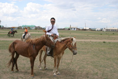 Even guys with ties ride horses!