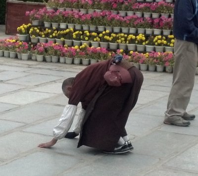 Buddhist pilgrims progress by body length well into the night