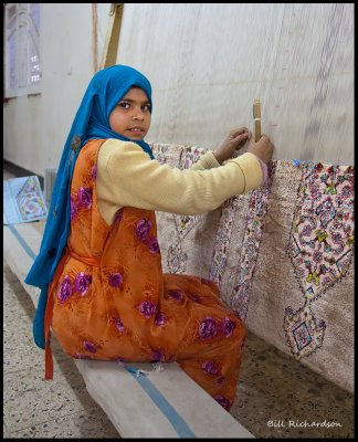 little girl weaving rug.jpg