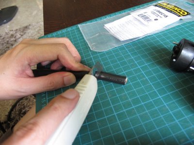 Use a pen knife to cut off the rubber sheath. Around 4cm.