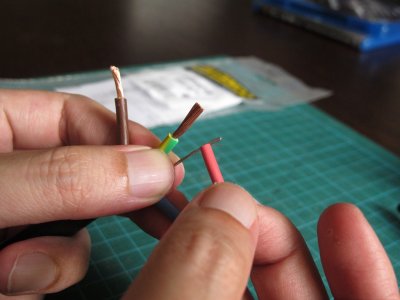Cut off a small piece of heat shrink and insert over the bare drain wire