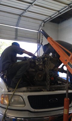nate and cleo removing an engine