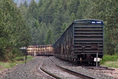 Headlights reflect off the stored boxcars at Cyr, MT.