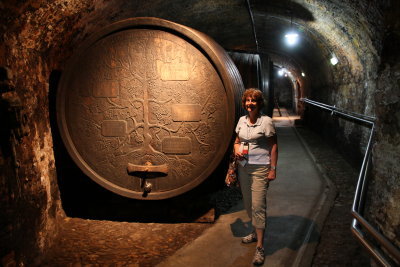 Jane next to one of the wine barrels