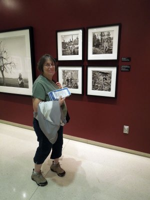 Judy enjoys the photos on display