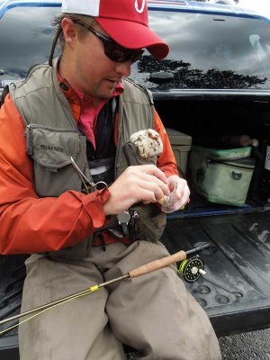 Andy ties a fly (a lure, not a live fly) to his line