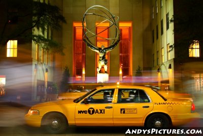 NYC Taxi stops in front of the Atlas Statue