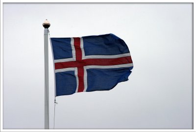 Icelandic national flag against grey sky