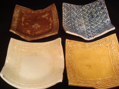 Small porcelian dishes; upper right and lower left are clear glaze over georgies pigments.