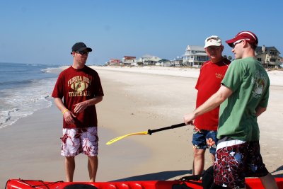 Jon and Jarrod explain to Mike how to kayak