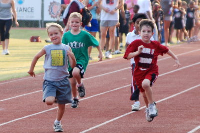 Brooks, Carter, and Hudson running in the 100m race