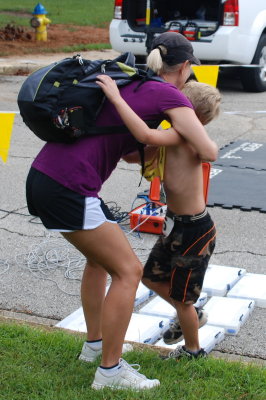 Brooks gets a hug from Mom as he finishes the run