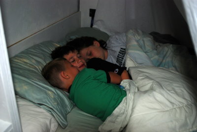 Cousins sleeping in the tent bed