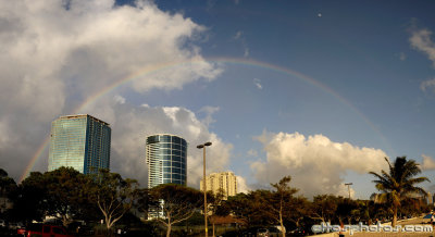 Rainbow and the moon over Honolulu