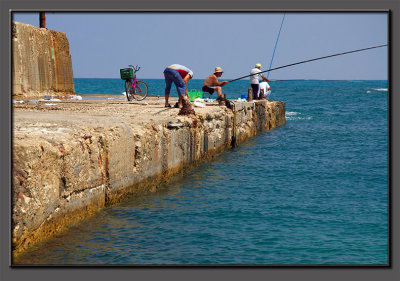 Fishermen at the ancient Caesarea's harbour