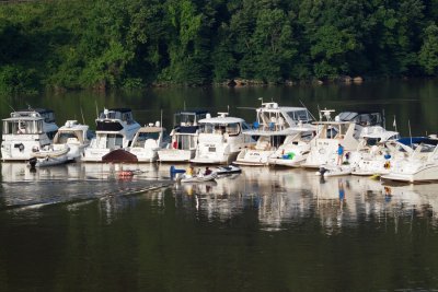 Boats line up facing upstream