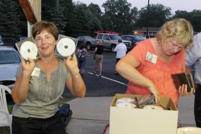 Mary Tubbs Dove and Patty Sommer Henize go through a box of CD's Mark Miller brought to share