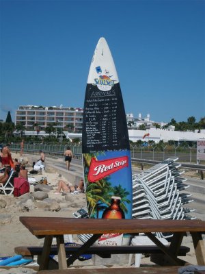 (Borrowed photo) Arriving flights listed on surfboard at Maho Beach