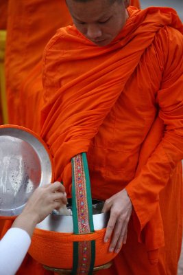 Monk receiving an offer