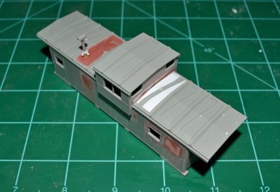 New roof ribs, side window and raised copula, getting closer to looking like a Katy caboose every minute.