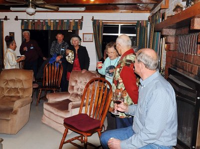 THE MAIN ROOM HAS A BEAUTIFUL FIREPLACE AND COMFORTABLE CHAIRS
