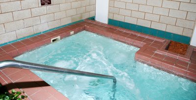 THE POOL AREA HAS A WARM JACCUZI TO RELAX IN AFTER ANY ACTIVITY AT THE SPORTS FITNESS CENTER