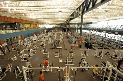 BEYOND THE FAR WALL OF THE FITNESS CENTER ARE THE BASKETBALL COURTS
