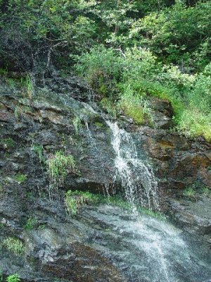 A WATER FALL ALONG THE ROAD