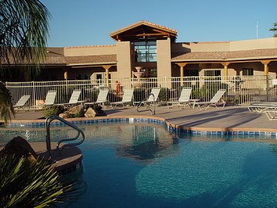 VIEW OF THE BACK OF THE HALL WITH POOL IN THE FOREGROUND