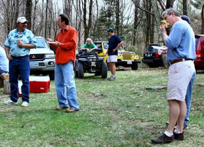 Damon, Randy, guest with Charlie, and Scott eating a burger in two bites