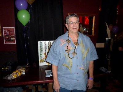 Tim Welcomes Everyone to the Halfway to Mardi Gras Party with Beads